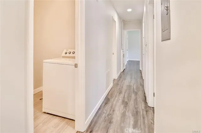 a view of a hallway with wooden floor