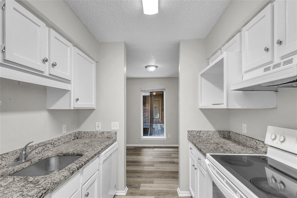 8109 Skillman Street, Unit 2007 Dallas, TX 75231 - Photo 7 of 11 a kitchen with granite countertop a sink dishwasher stove and cabinets