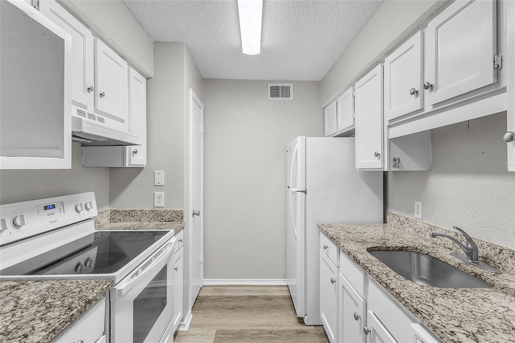 8109 Skillman Street, Unit 2007 Dallas, TX 75231 - Photo 9 of 11 a kitchen that has a sink and a stove