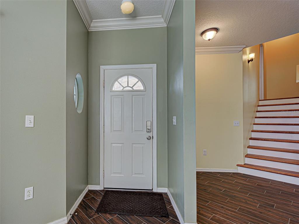 1801 Highland Road Osprey, FL 34229 - Photo 5 of 40 a view of a hallway with wooden floor and staircase