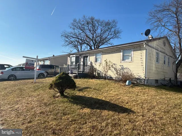 a backyard of a house with barbeque oven and table