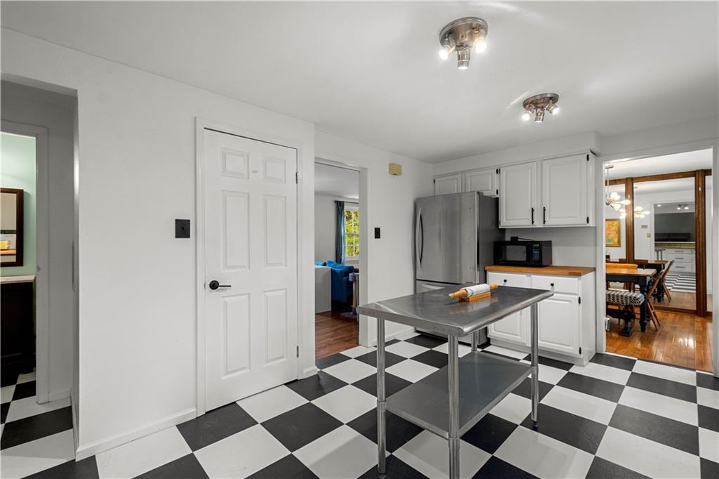 596 Clifton Road Bethel Park, PA 15102 - Photo 12 of 36 a kitchen with a checkered floor and black appliances