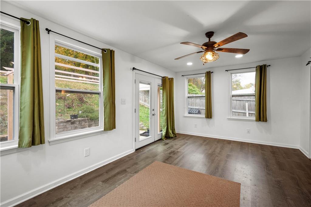 596 Clifton Road Bethel Park, PA 15102 - Photo 17 of 36 a view of an empty room with a window and wooden floor