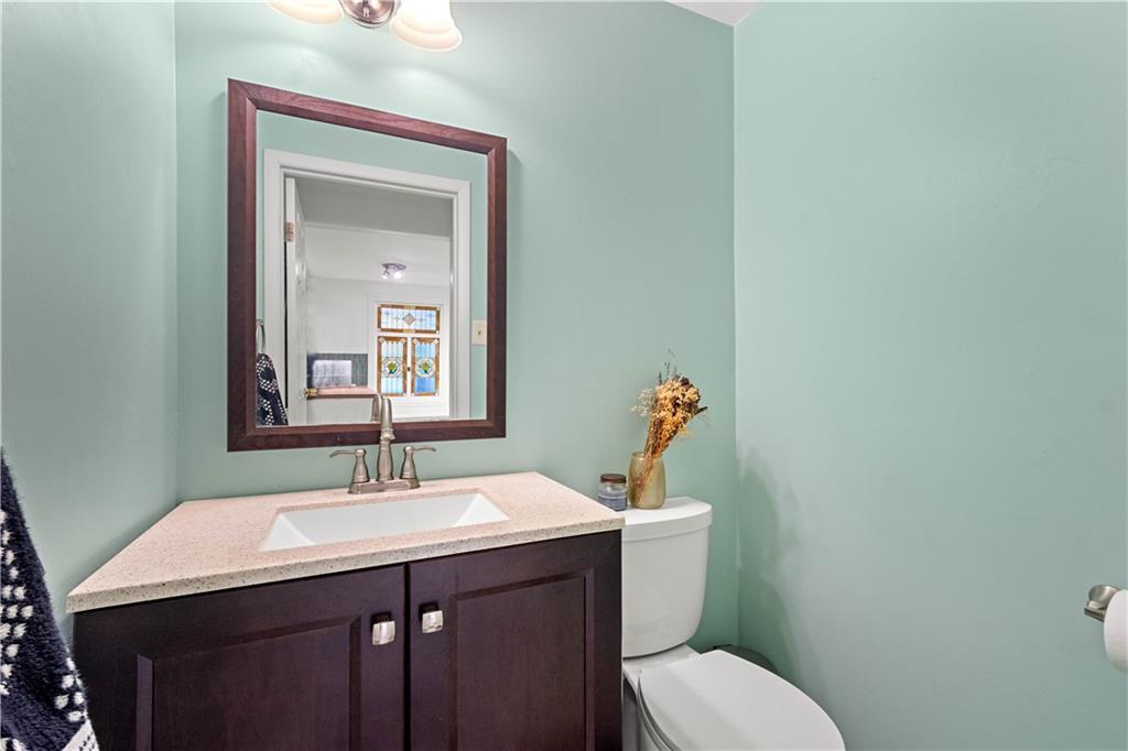 596 Clifton Road Bethel Park, PA 15102 - Photo 18 of 36 a bathroom with a sink vanity mirror and toilet