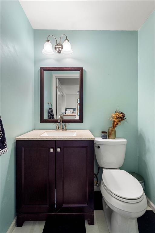 596 Clifton Road Bethel Park, PA 15102 - Photo 19 of 36 a bathroom with a sink vanity mirror and toilet