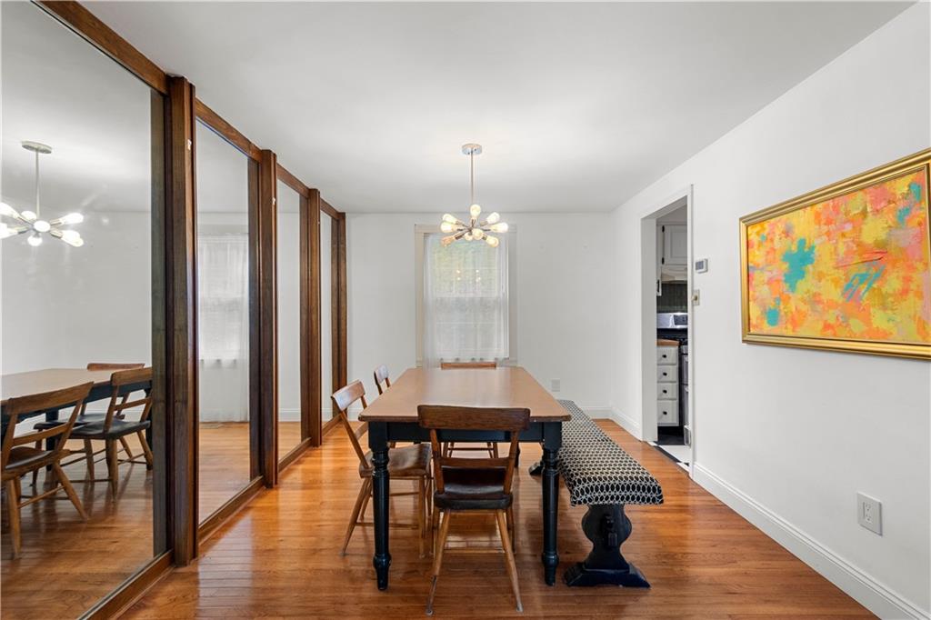 596 Clifton Road Bethel Park, PA 15102 - Photo 7 of 36 a dining room with furniture a chandelier and wooden floor
