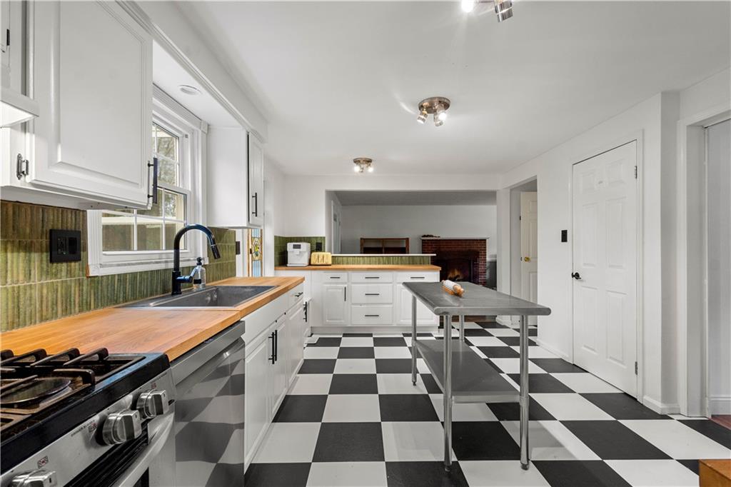 596 Clifton Road Bethel Park, PA 15102 - Photo 9 of 36 a kitchen with a sink a stove and a refrigerator