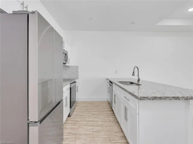 a kitchen with a sink and refrigerator