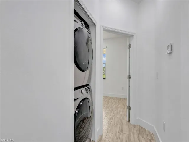 a view of a bedroom with washer and dryer