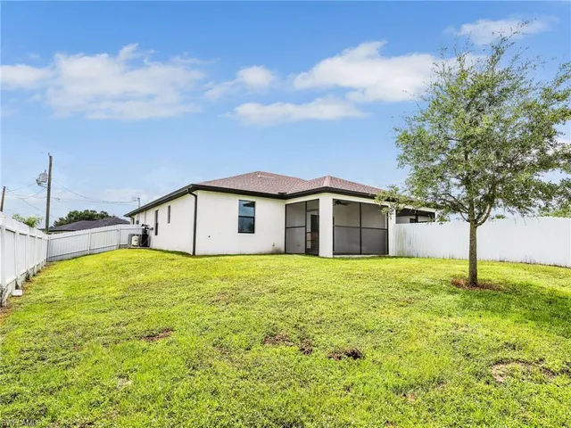 a house with a big yard and large trees