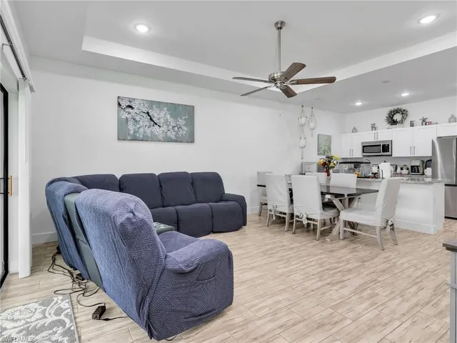 a living room with furniture a ceiling fan and a rug