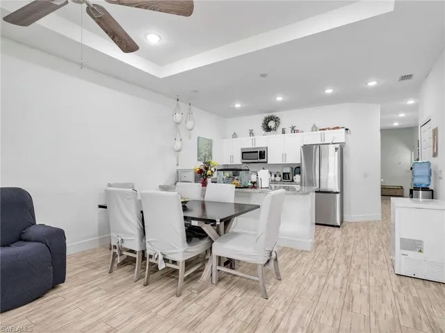 a view of kitchen with refrigerator and wooden floor