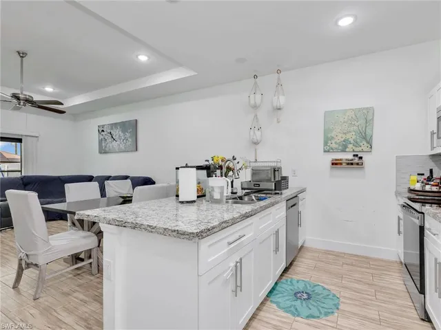 a kitchen that has a sink and a stove in it