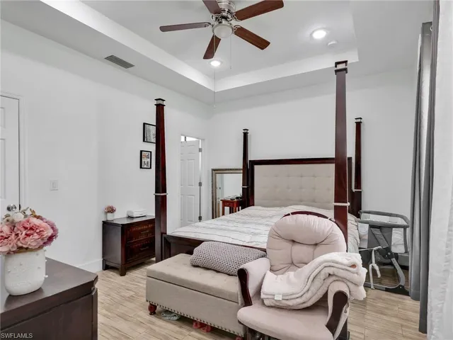 a bedroom with a bed couch and a window