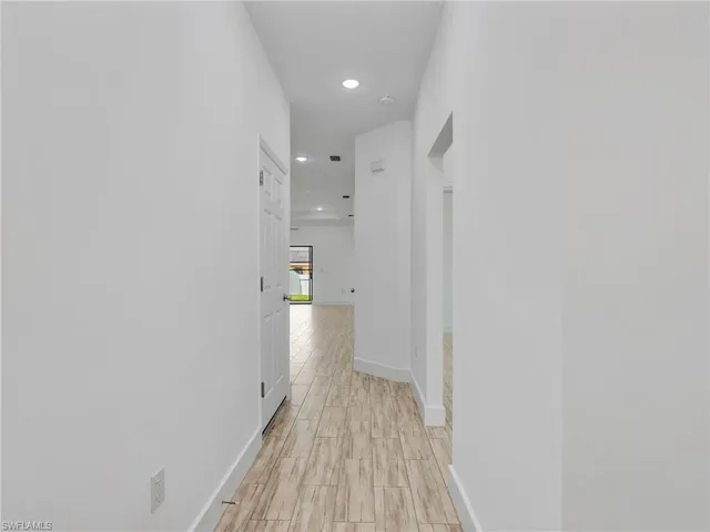 a view of a room with wooden floor and a bathroom
