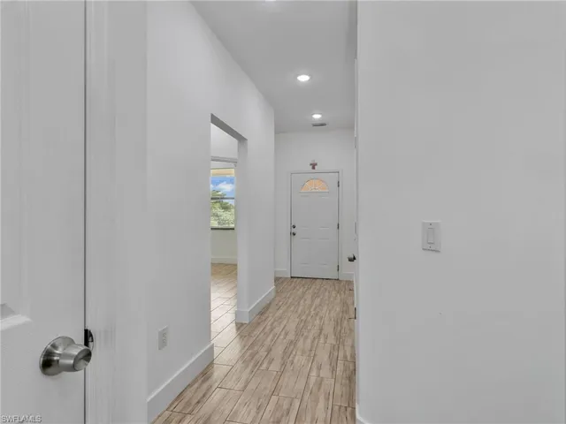 a view of a hallway with wooden floor
