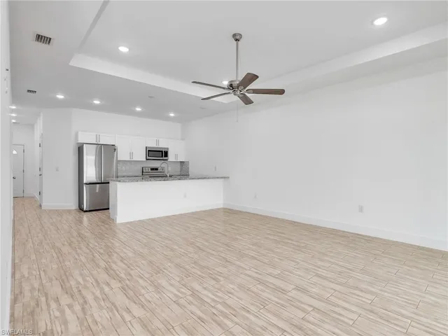 a view of a kitchen with a sink and a refrigerator