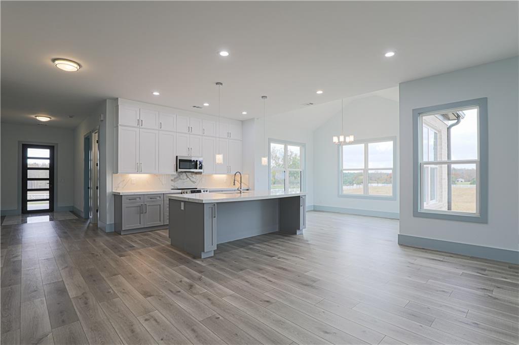 1480 Wheeler Cemetery Road Maysville, GA 30558 - Photo 16 of 50 a large kitchen with stainless steel appliances granite countertop a large counter top and a wooden floors
