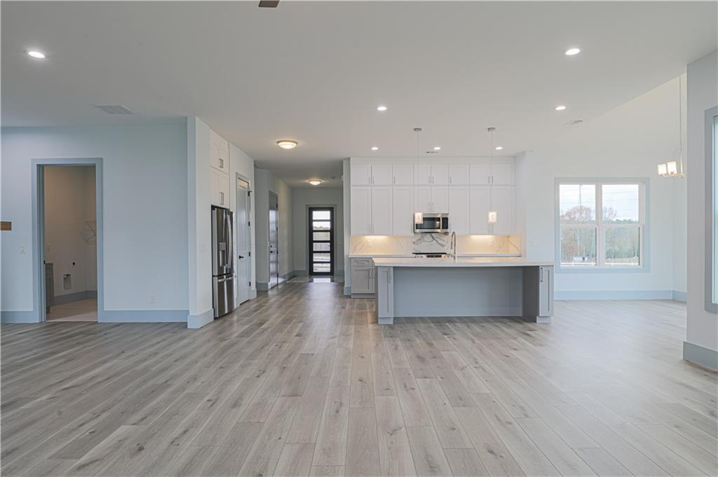 1480 Wheeler Cemetery Road Maysville, GA 30558 - Photo 17 of 50 a room with stainless steel appliances kitchen island wooden floors and view living room