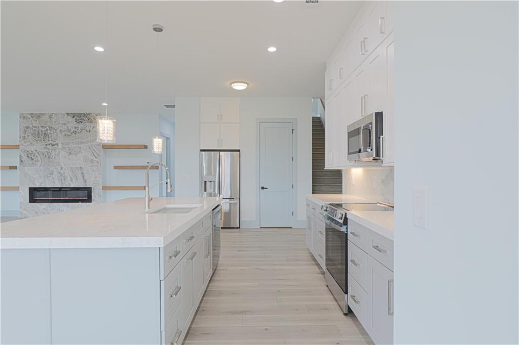 1480 Wheeler Cemetery Road Maysville, GA 30558 - Photo 25 of 50 a large white kitchen with a white stove top oven and white cabinets