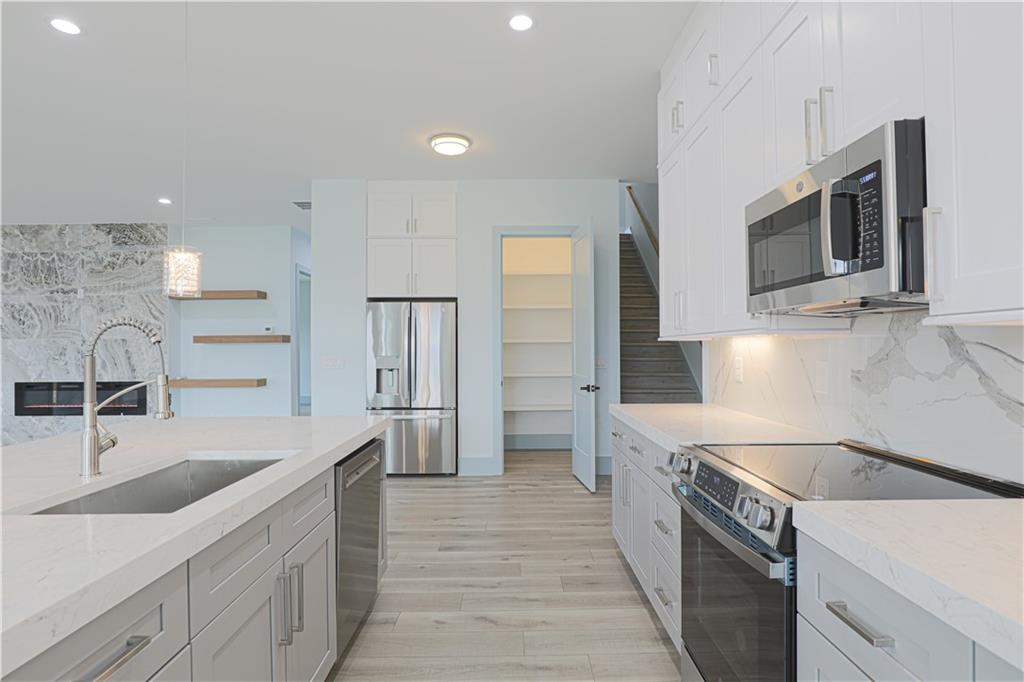 1480 Wheeler Cemetery Road Maysville, GA 30558 - Photo 26 of 50 a kitchen with stainless steel appliances granite countertop a sink and refrigerator