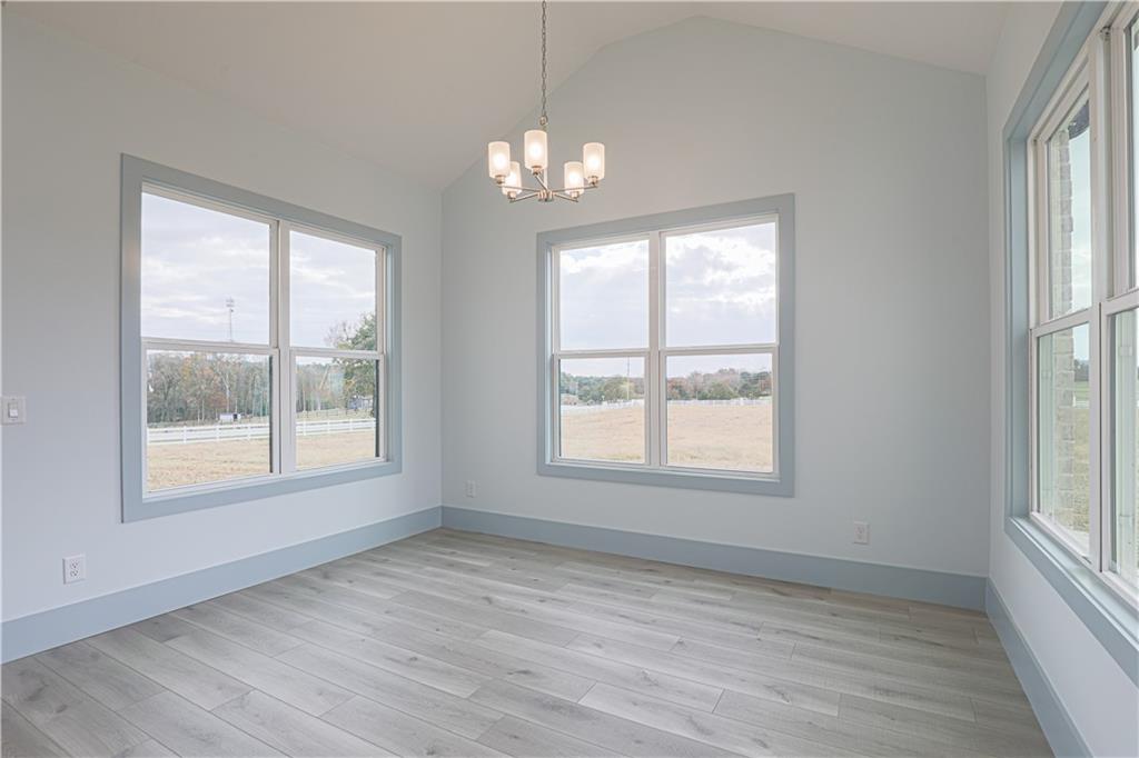 1480 Wheeler Cemetery Road Maysville, GA 30558 - Photo 27 of 50 a view of an empty room with wooden floor and a window