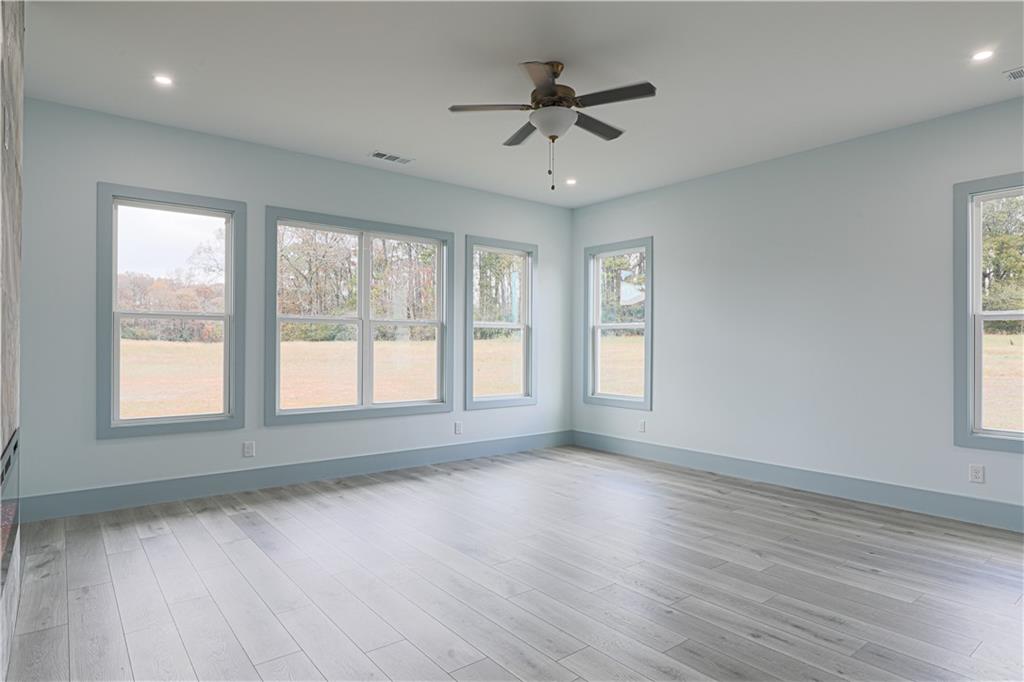 1480 Wheeler Cemetery Road Maysville, GA 30558 - Photo 29 of 50 a view of an empty room with wooden floor and a window