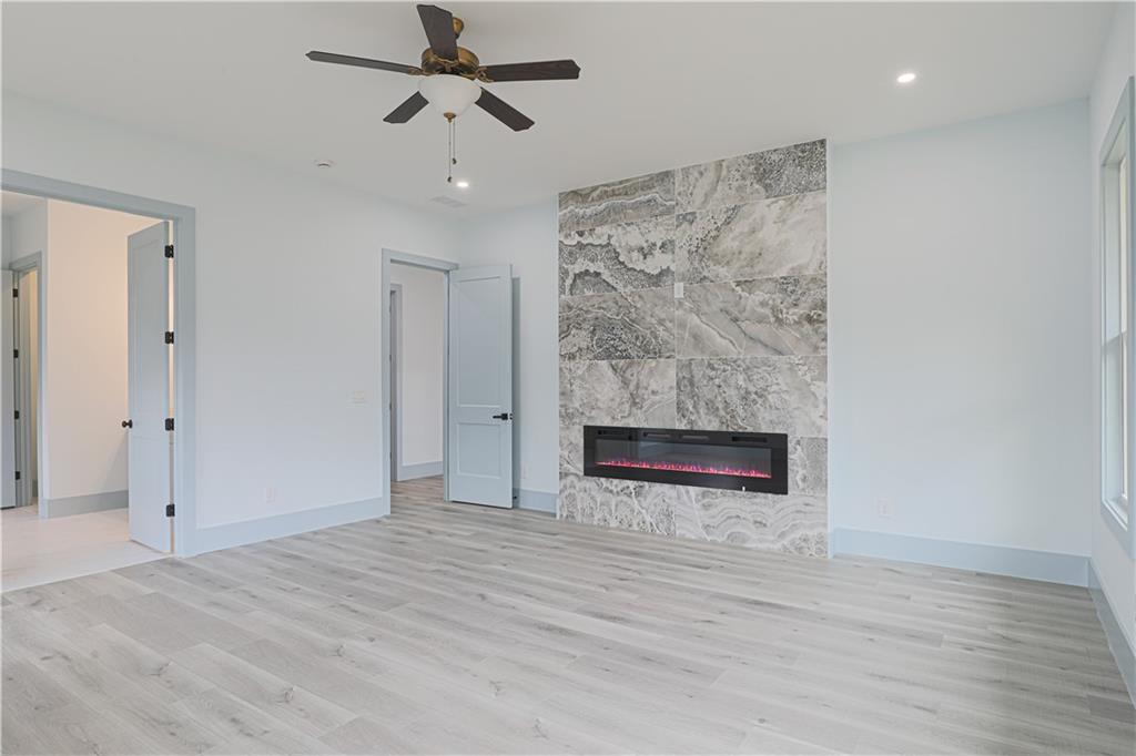 1480 Wheeler Cemetery Road Maysville, GA 30558 - Photo 31 of 50 an empty room with wooden floor and ceiling fan