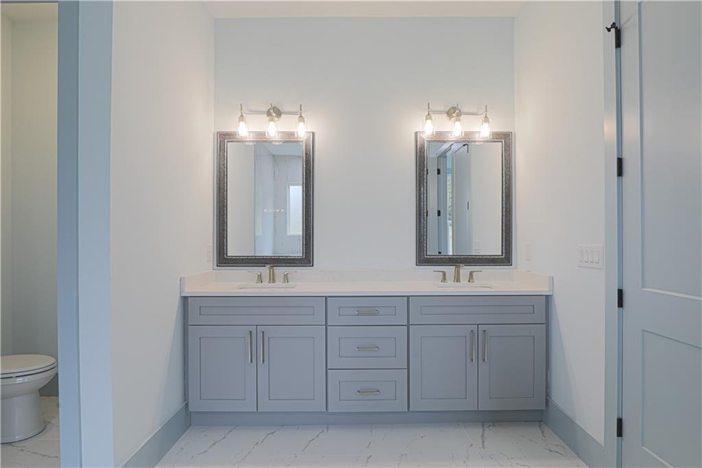 1480 Wheeler Cemetery Road Maysville, GA 30558 - Photo 34 of 50 a bathroom with a double vanity sink and a mirror