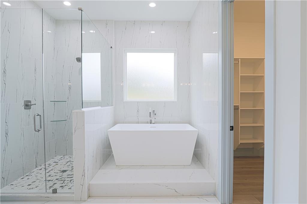 1480 Wheeler Cemetery Road Maysville, GA 30558 - Photo 35 of 50 a white bath tub sitting in a bathroom and shower