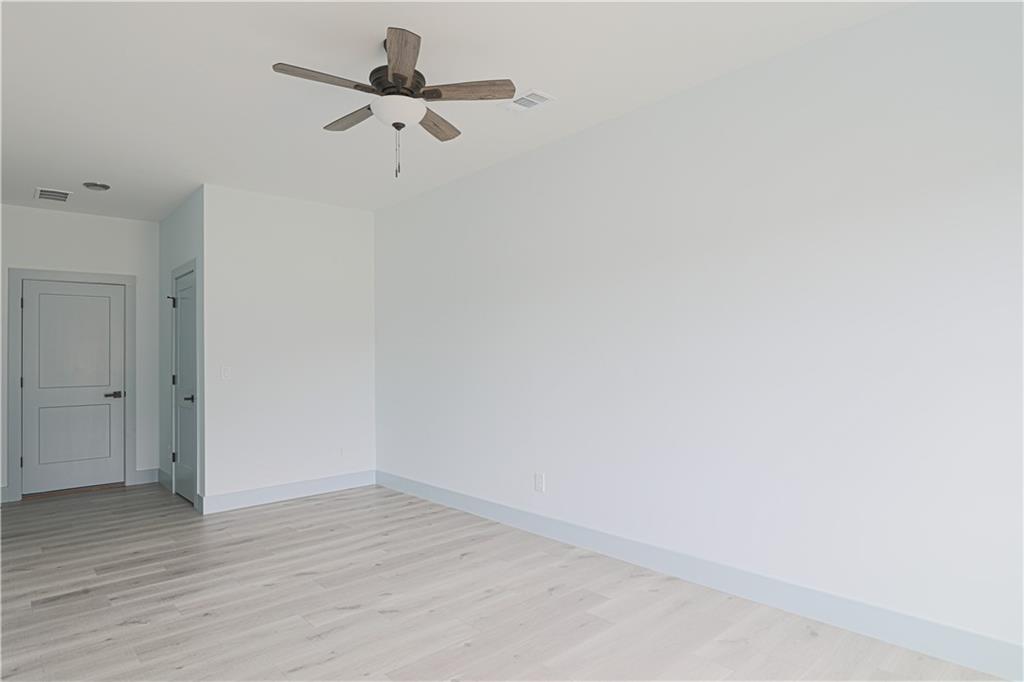 1480 Wheeler Cemetery Road Maysville, GA 30558 - Photo 45 of 50 a view of a room with wooden floor and a ceiling fan