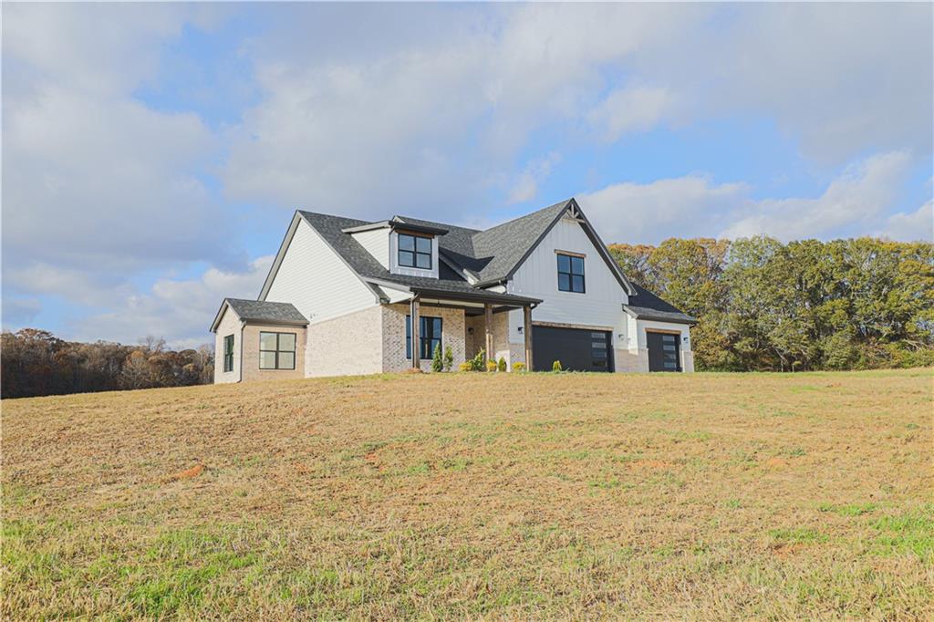 1480 Wheeler Cemetery Road Maysville, GA 30558 - Photo 46 of 50 a front view of a house with a yard and garage