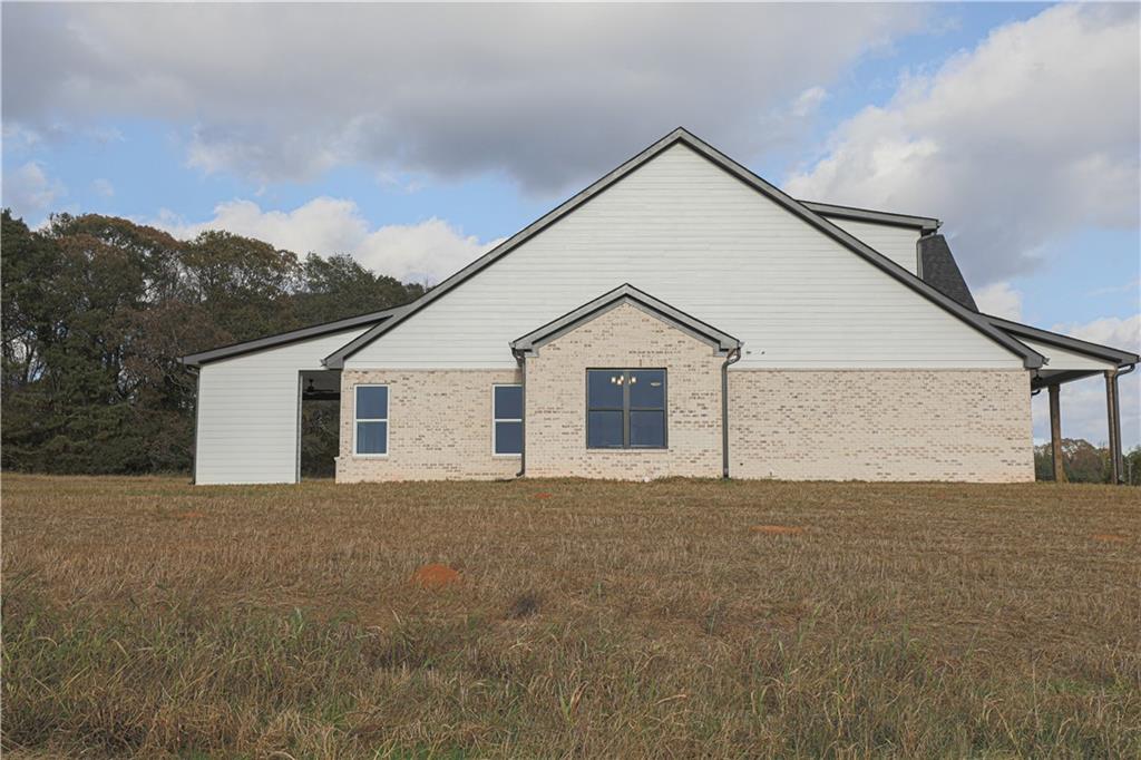 1480 Wheeler Cemetery Road Maysville, GA 30558 - Photo 47 of 50 a view of a house with a yard and garage