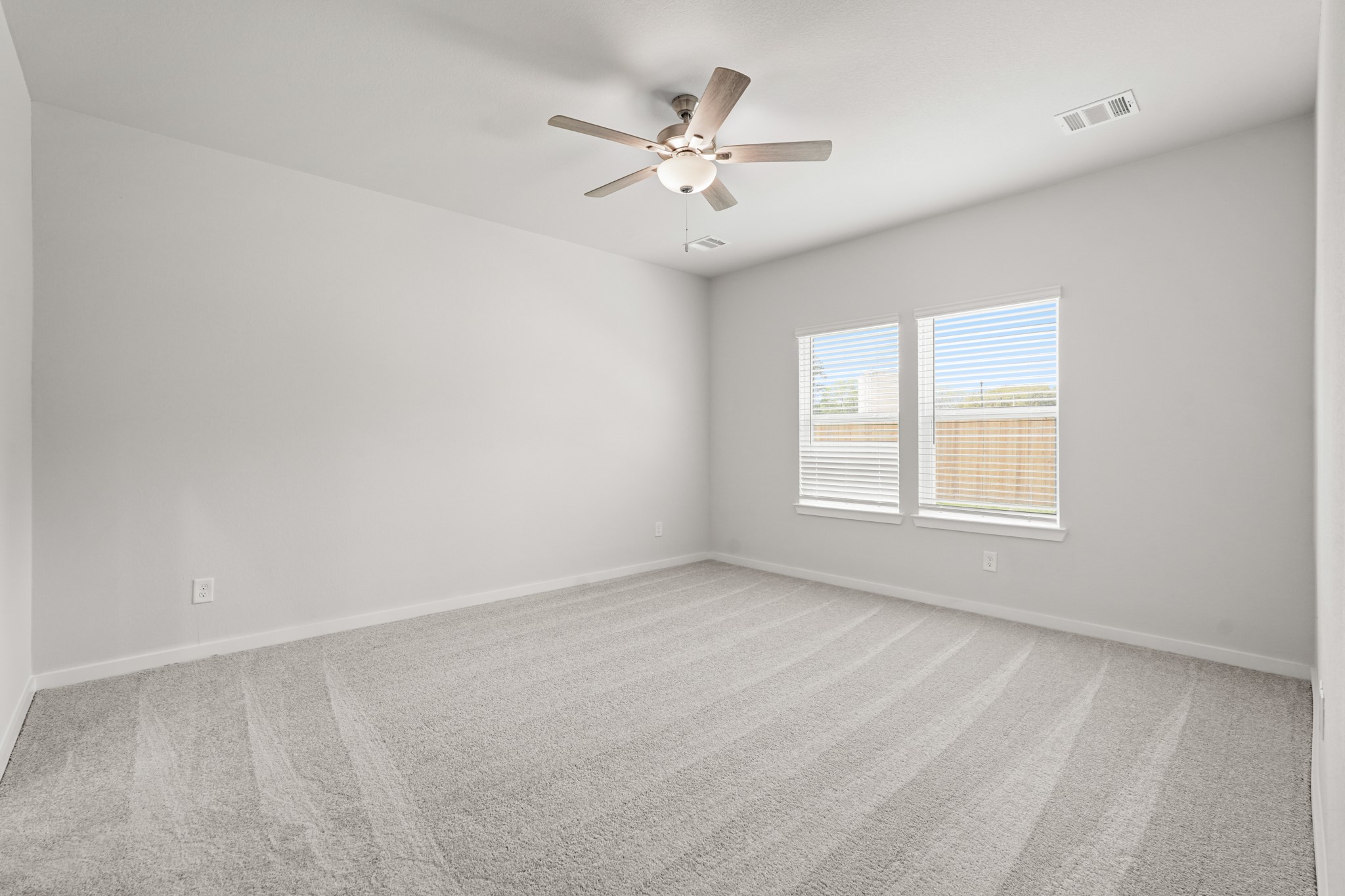 213 Spring Drive Hockley, TX 77447 - Photo 13 of 26 an empty room with a window and a ceiling fan