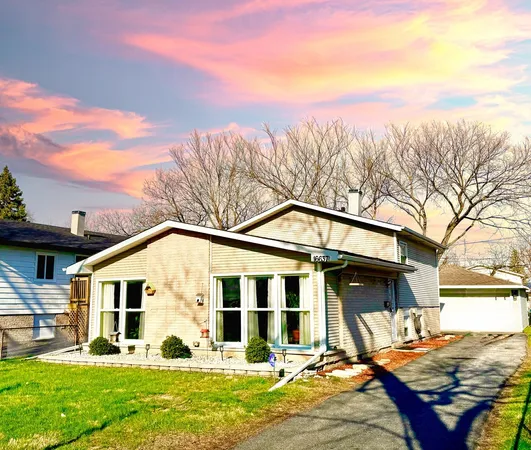 a view of a house with a yard and sitting area