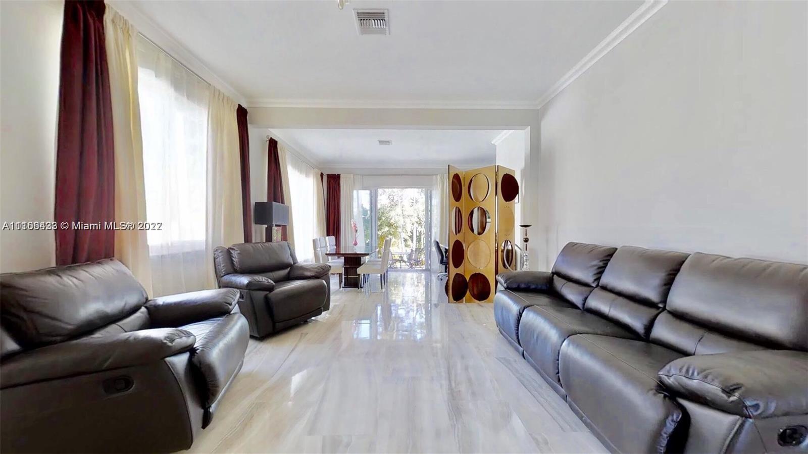 9033 Byron Avenue Surfside, FL 33154 - Photo 17 of 25 a living room with furniture and a large window