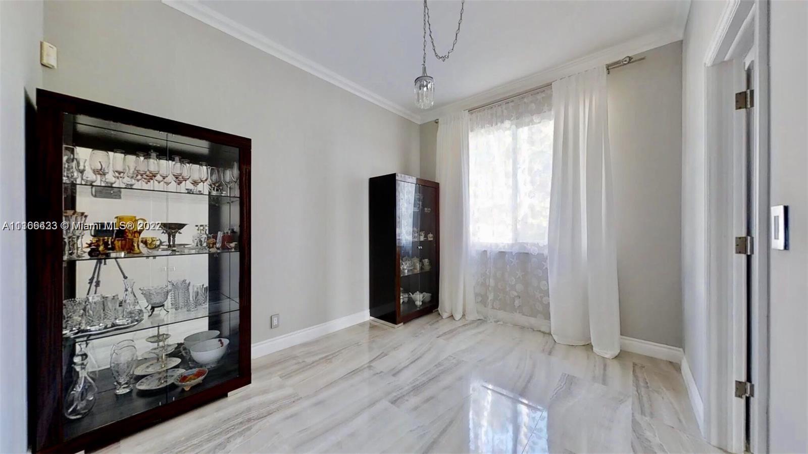 9033 Byron Avenue Surfside, FL 33154 - Photo 18 of 25 a view of a hallway with wooden floor and closet