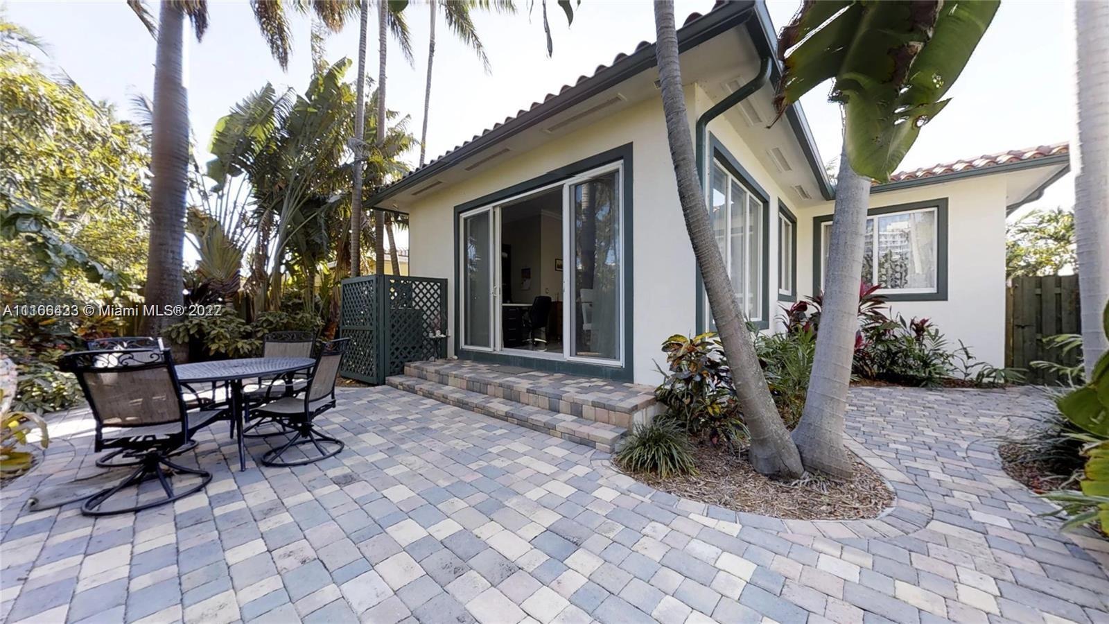 9033 Byron Avenue Surfside, FL 33154 - Photo 2 of 25 a front view of a house with sitting area