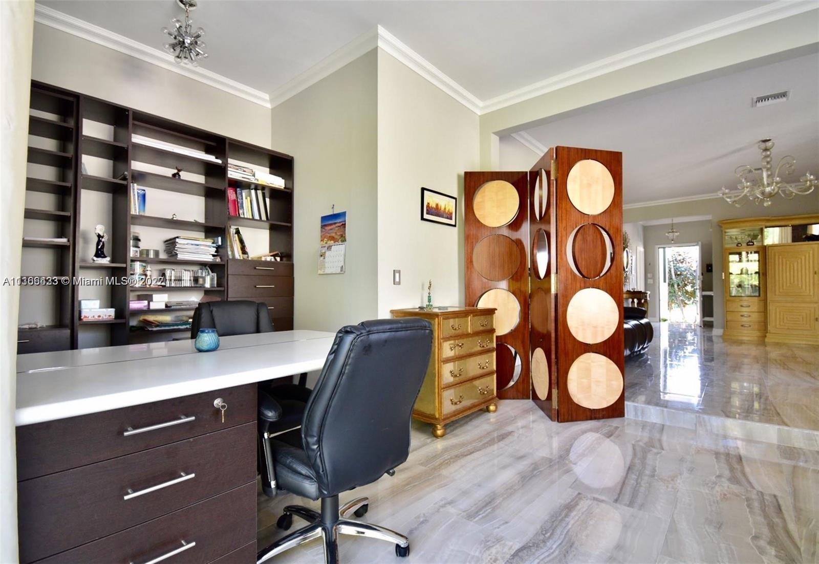 9033 Byron Avenue Surfside, FL 33154 - Photo 21 of 25 a view of a workspace room with wooden floor and windows
