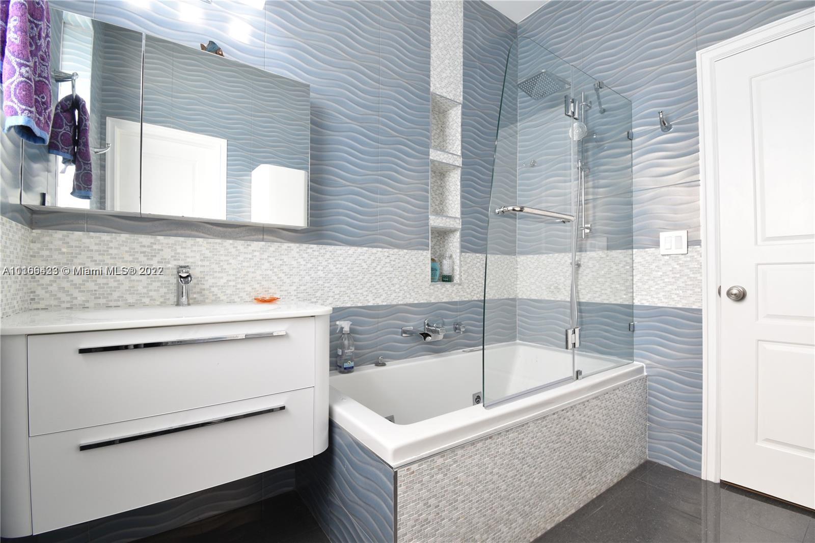 9033 Byron Avenue Surfside, FL 33154 - Photo 23 of 25 a bathroom with a bathtub and a sink