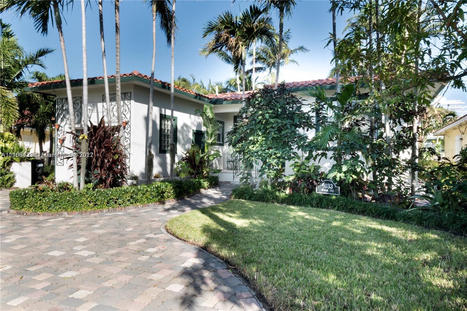 9033 Byron Avenue Surfside, FL 33154 - Photo 4 of 25 a view of a house with a yard and potted plants