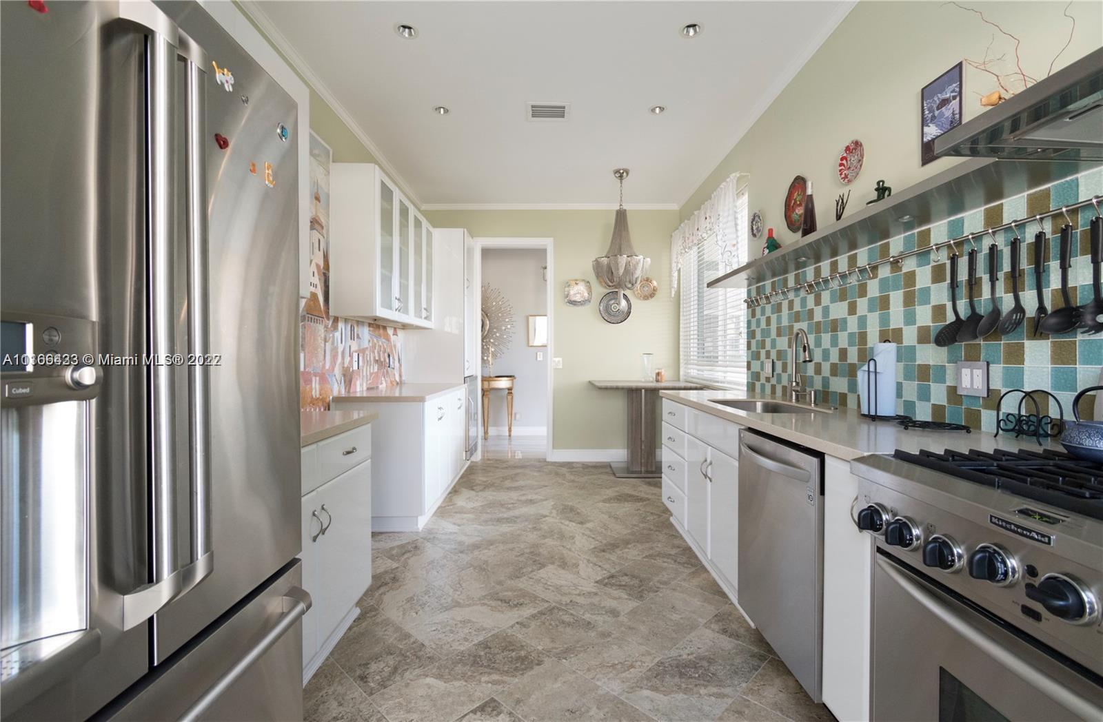 9033 Byron Avenue Surfside, FL 33154 - Photo 7 of 25 a kitchen with stainless steel appliances granite countertop a refrigerator and a stove