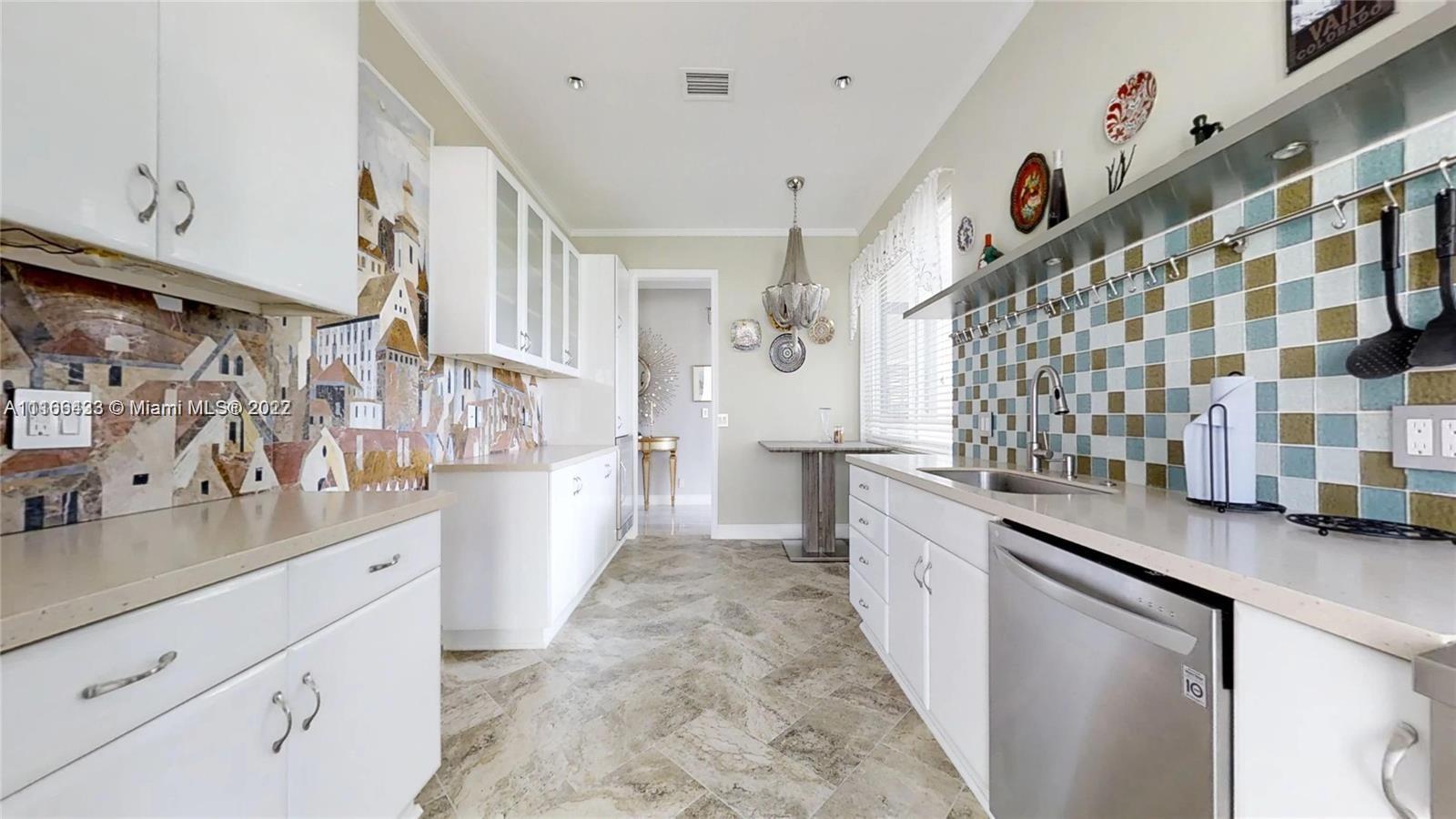 9033 Byron Avenue Surfside, FL 33154 - Photo 8 of 25 a large white kitchen with a lot of counter space