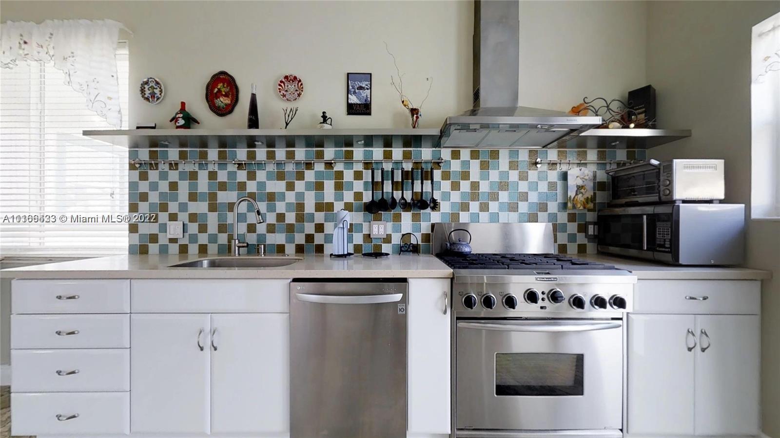 9033 Byron Avenue Surfside, FL 33154 - Photo 10 of 25 a stove top oven sitting inside of a kitchen