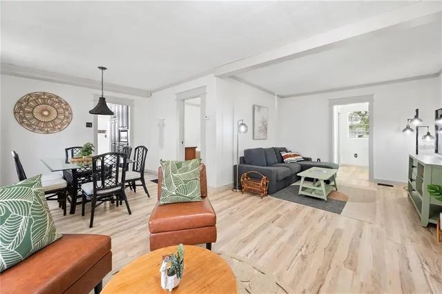 a living room with furniture a clock on wall and a table