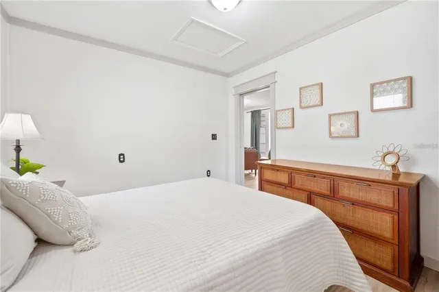 a bedroom with a bed and painting on the wall