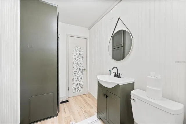 a bathroom with a sink mirror and toilet
