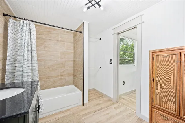 a bathroom with a bathtub and a shower