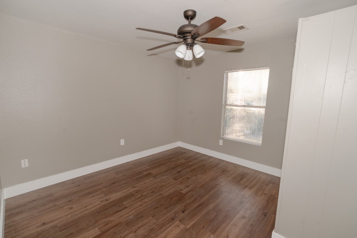 4826 Bristol Street Houston, TX 77009 - Photo 14 of 25 wooden floor in an empty room with a window