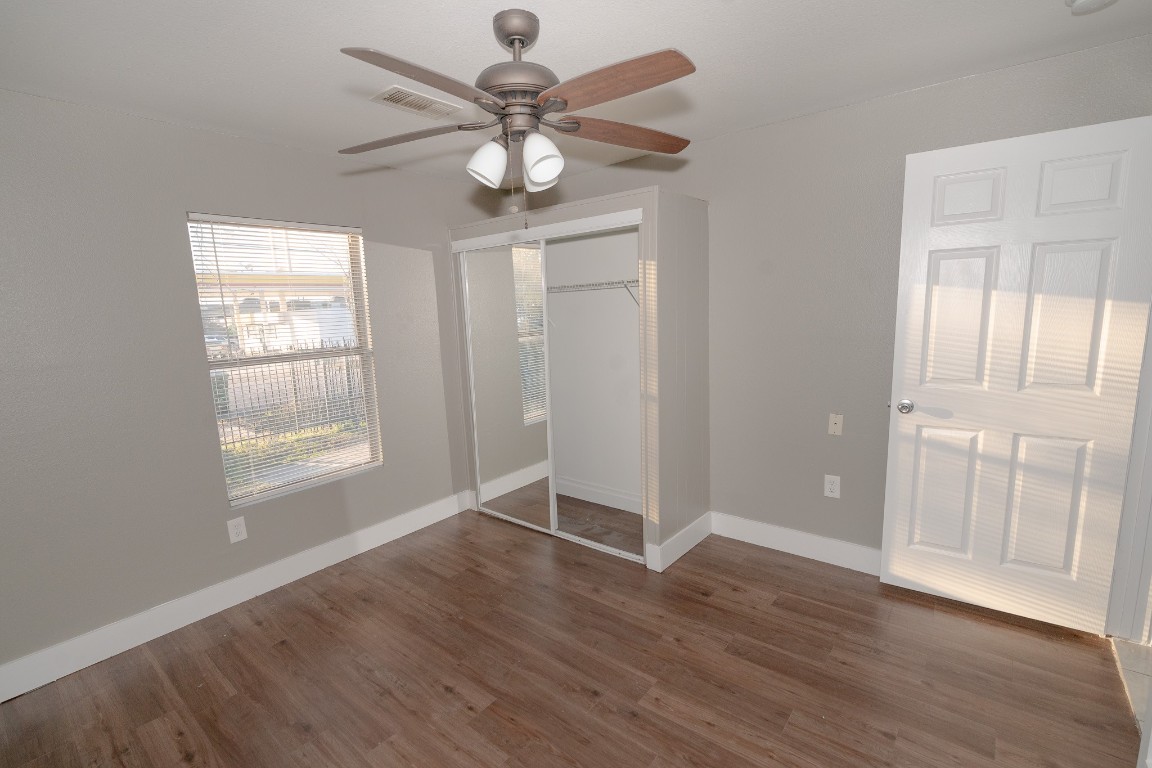 4826 Bristol Street Houston, TX 77009 - Photo 15 of 25 an empty room with wooden floor fan and windows